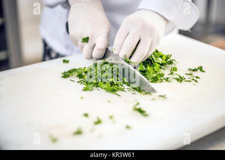 Cook's hands cutting parsley Stock Photo