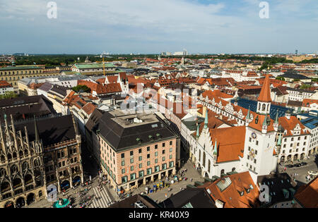 Beautiful super wide-angle sunny aerial view of Munich, Bayern, Bavaria, Germany with skyline and scenery beyond the city, seen from the observation deck of St. Peter Church Stock Photo