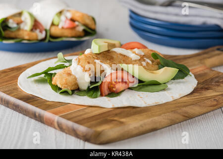Fish finger wraps with avocado and tomato Stock Photo