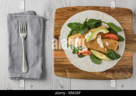 Fish finger wraps with avocado and tomato Stock Photo