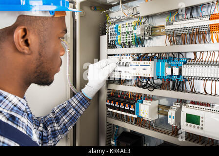 Technician Checking Fusebox Stock Photo