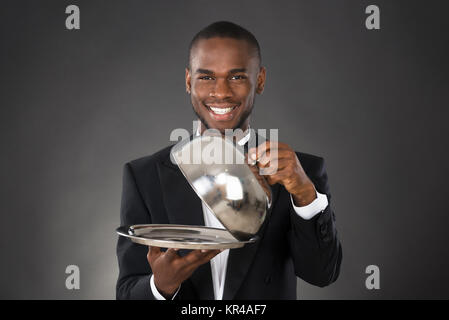 Waiter Serving Meal In Cloche Stock Photo
