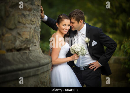 Beautiful, happy, younf wedding couple in a splendid historic castle environment, walking up the stairs, shining with happiness Stock Photo