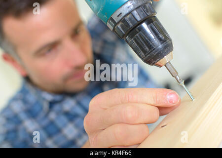 Man using an electric screwdriver Stock Photo