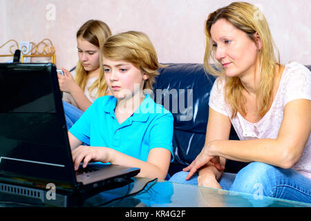 mother and her children using computer Stock Photo