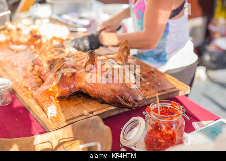 Roasted suckling pig served on food stall. Stock Photo