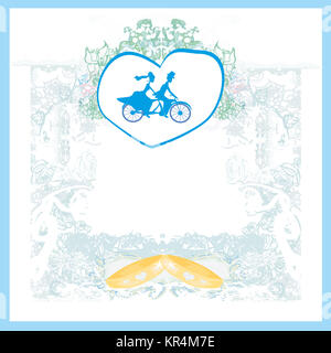 wedding invitation with bride and groom riding tandem bicycle Stock Photo