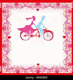 wedding invitation with bride and groom riding a tandem bicycle Stock Photo