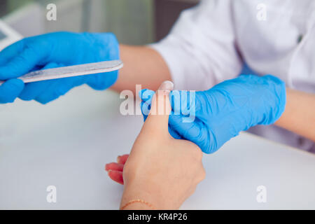 Woman in  Spa nail salon receiving manicure. Stock Photo