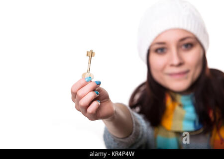 Full body portrait of young happy smiling business woman or real estate agent showing keys from new house, isolated on white background Stock Photo