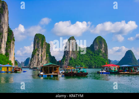 Floating village and rock islands in Halong Bay Stock Photo