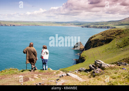 Green fields lead down to cliffs and sea at Newport Bay, seen from Dinas Head in the Pembrokeshire Coast National Park, Wales. Stock Photo