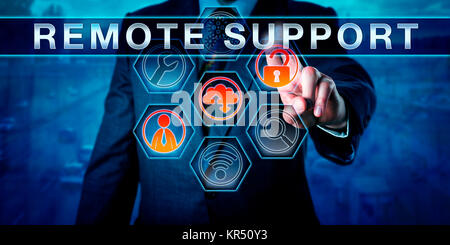 Male IT Technician Pressing REMOTE SUPPORT Stock Photo