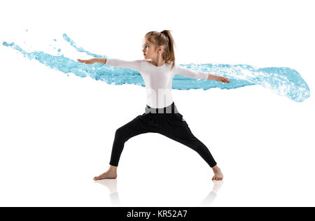 Little girl practice yoga in water splashes. Stock Photo