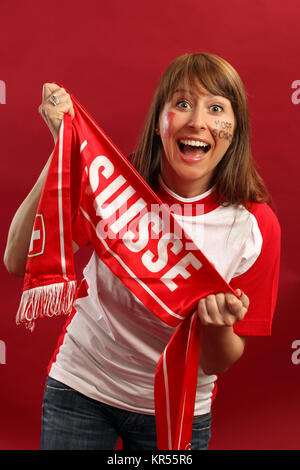 Photo of a female Swiss sports fan smiling and cheering for their team. Stock Photo