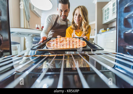 couple with burnt pizza Stock Photo