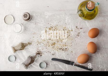 Eggs with  herb mix and olive oil on the white table Stock Photo