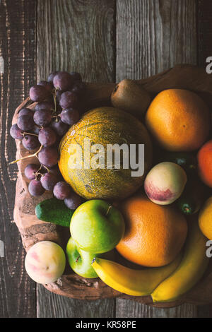 Fruit mix on the wooden bowl top view vertical Stock Photo