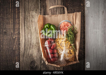 Food mix  inside a paper bag on the wooden background horizontal Stock Photo