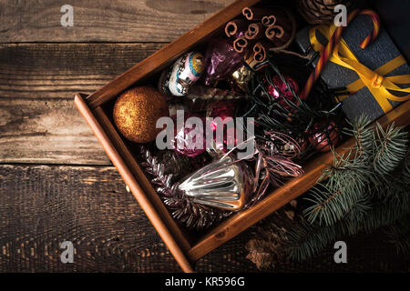 Wooden box with Christmas decorations and gift top view Stock Photo