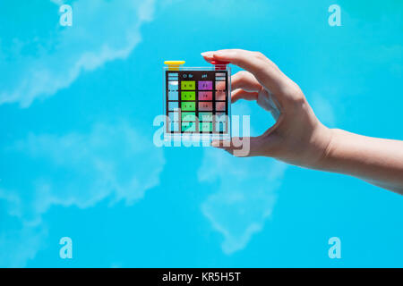 measuring chlorine pollution in outdoor pool Stock Photo