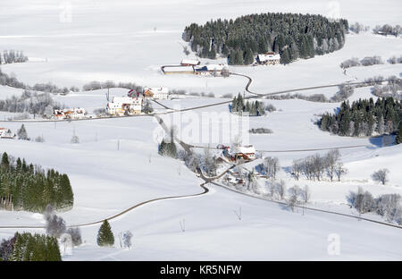 Lovely rural countryside on snowy winter day. Aerial view of barnyards and farm. Weitnau, Allgau, Bavaria, Germany. Stock Photo