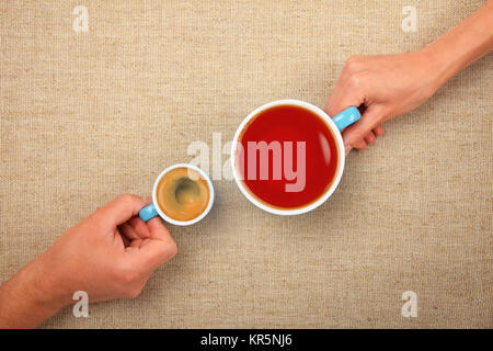 Two hands with espresso coffee and black tea cups Stock Photo