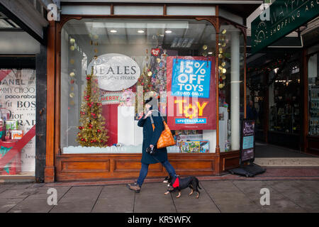 Southport, Merseyside, UK 18th December, 2017. Misty Foggy day for Christmas shopping in Lord Street as last minute shoppers head into the town centre to complete their festive purchases in dark, damp and cold winter weather.  Retailers, in the week before Christmas, are already discounting with pre-Christmas sales to encourage last-minute buying. Credit; MediaWorldImages/AlamyLiveNews. Stock Photo