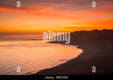 Lyme Regis, Dorset, UK.  18th December 2017.  UK Weather.   A spectacular sunset over Lyme Regis on the Jurassic Coast of Dorset after a day of sunshine and above average temperatures.  Photo Credit:  Graham Hunt/Alamy Live News Stock Photo