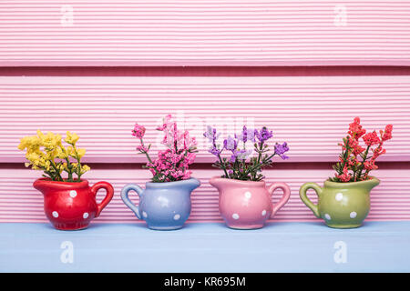 Small decorative artificial white flowers in pink pot Stock Photo - Alamy