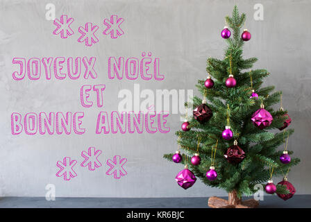 christmas tree,cement wall,bonnee annee means new year Stock Photo