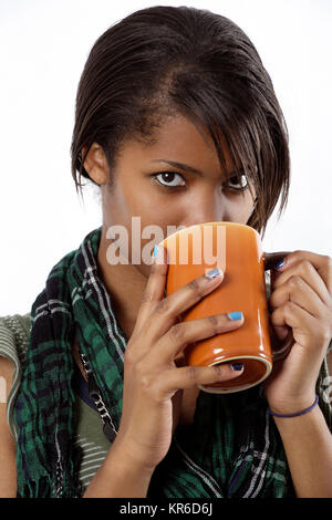 Photo of a beautiful female drinking from a mug of tea or coffee. Stock Photo