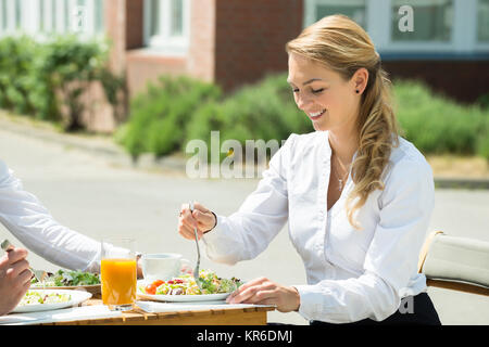 Businesswoman Eating Food Stock Photo