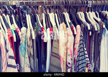 Clothes hanging on a rail Stock Photo