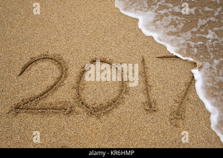 Number 2017 written on seashore sand. Concept of upcoming new year and passing of time. Stock Photo
