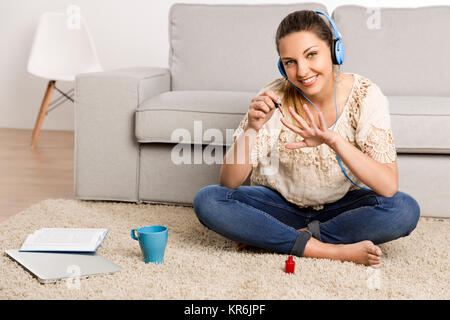 Making a pause to paint my nails Stock Photo