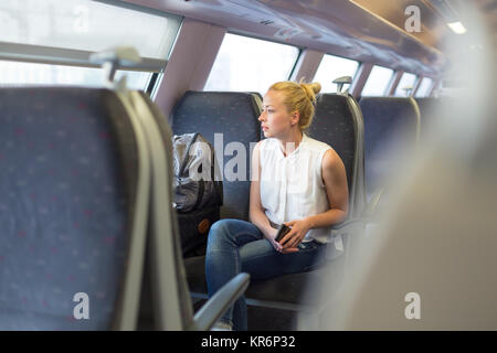 Woman travelling by train. Stock Photo
