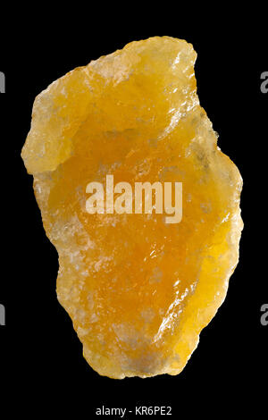 Raw, uncut orange calcite (CaCO3) from Mexico isolated on black background Stock Photo
