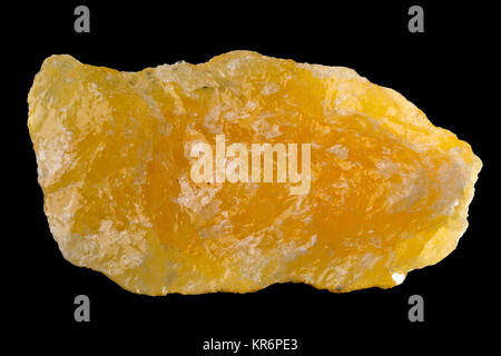 Raw, uncut orange calcite (CaCO3) from Mexico isolated on black background Stock Photo