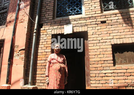 There are cracks in her home by 2015 earthquake. Still she and her husband live in this temporary shelter as of now her house is destroyed. Stock Photo