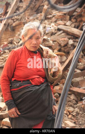 Women inspecting her house after 2015 earthquake shake in Bhaktapur. Stock Photo