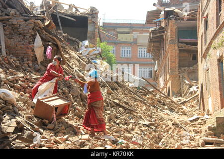 Women in Sankhu shifting the belonging after their houses are damaged on a 7.8 magnitude earthquake in Nepal on 25 April 2015. Stock Photo