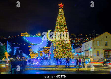 HAIFA, ISRAEL - DECEMBER 13, 2017: The German Colony, decorated for the holidays, with a Christmas tree, Hanukkah Menorah (in Peace Dove form), Muslim Stock Photo