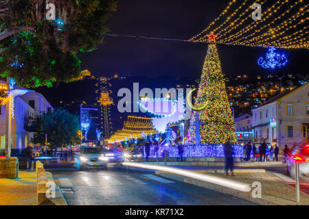 HAIFA, ISRAEL - DECEMBER 13, 2017: The German Colony, decorated for the holidays, with a Christmas tree, Hanukkah Menorah (in Peace Dove form), Muslim Stock Photo