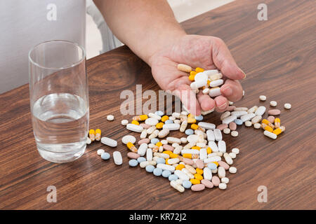 Person's Hand Holding Pills Stock Photo