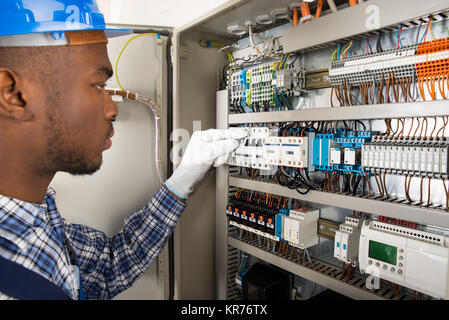 Technician Checking Fusebox Stock Photo