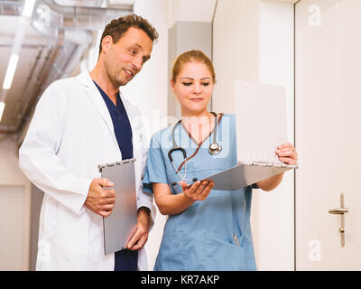 Doctor and nurse discussing charts Stock Photo