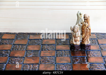 three chess pieces on a chessboard. together and cohesion in the game and in life Stock Photo