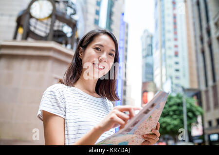 Woman use of city map in Hong Kong Stock Photo