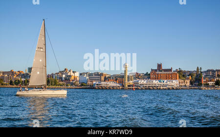 Australia, New South Wales, Hunter region, Newcastle, a sleek yacht is passing the Newcastle waterfront with view of Queens Wharf, the Queens Wharf To Stock Photo